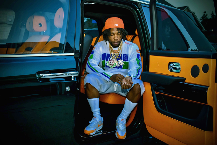 Rapper Curren$y sitting in car