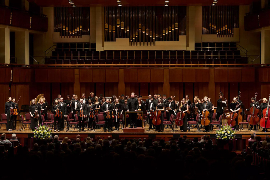 Orchestra playing on stage at The Kennedy Center 